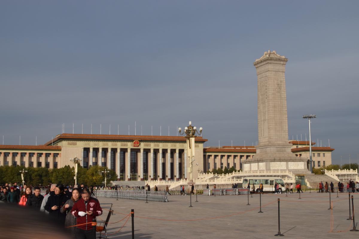 Crowds queue on Tiananmen Square near the Monument to the People&rsquo;s Heroes and the Great Hall of the People