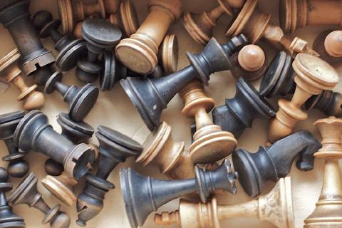 A jumbled pile of wooden chess pieces