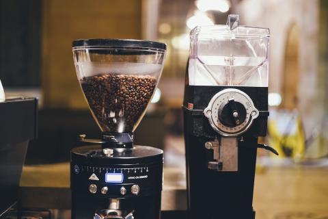A café coffee grinder labeled GRIND ON DEMAND, one button below the bean hopper