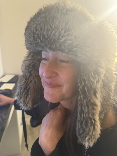Jen in a fur trapper hat, smiling